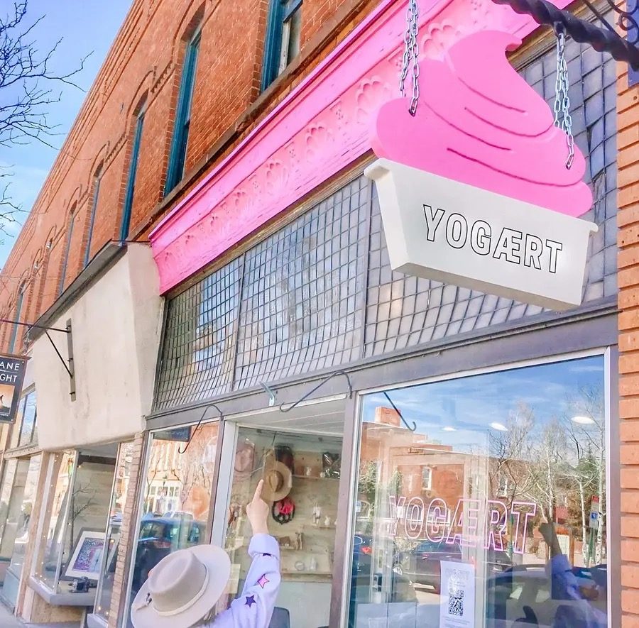 The Yog&aelig;rt storefront at 3 E Aspen Ave, marked by a pink soft-serve sign above the sidewalk.